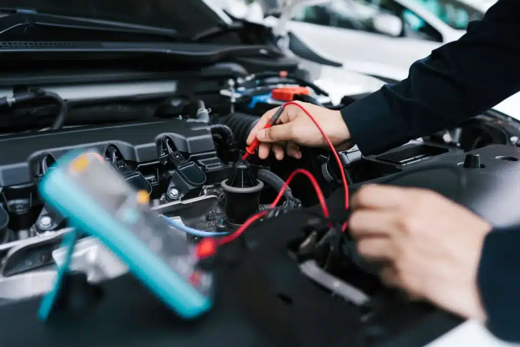 Technician using diagnostic equipment to analyze engine performance at Schindler's Garage.