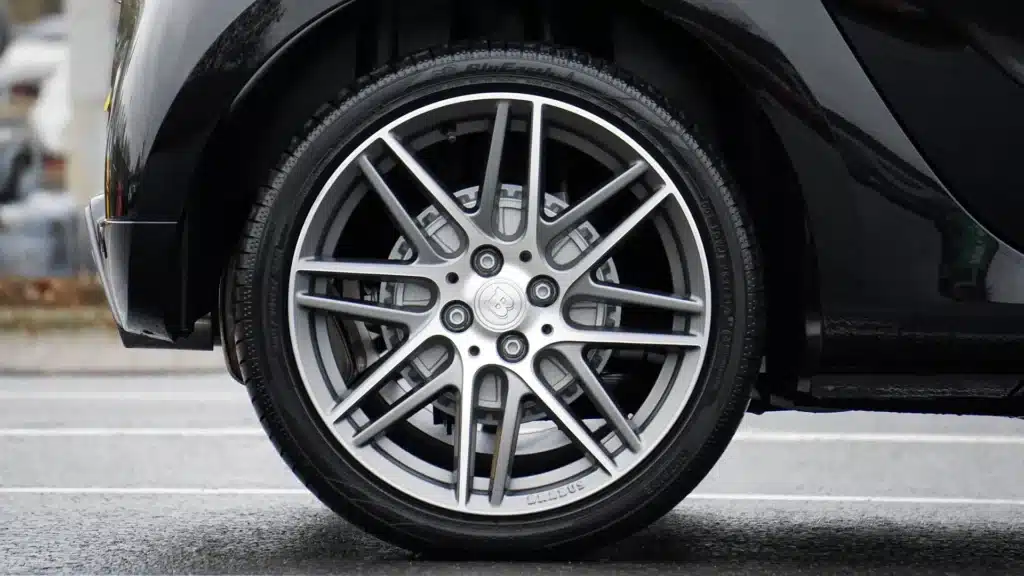 Close-up of backend vehicle tires being during a maintenance service.