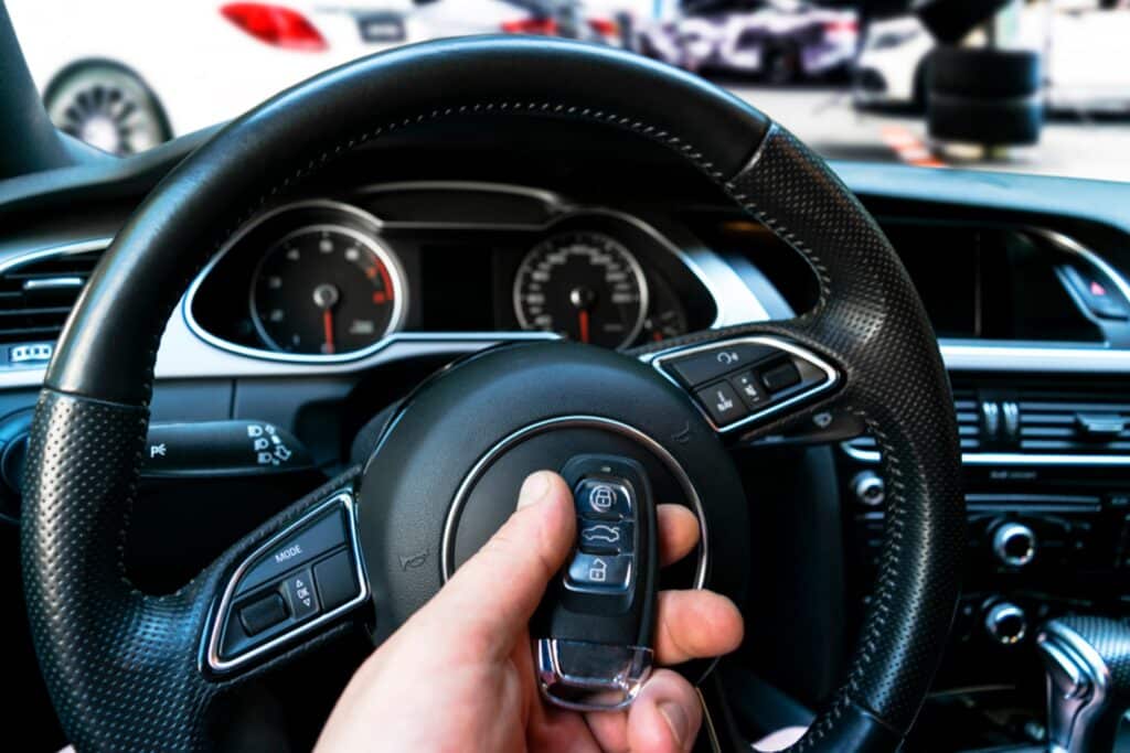 Close-up of a key fob being programmed with the vehicle's electronic system.