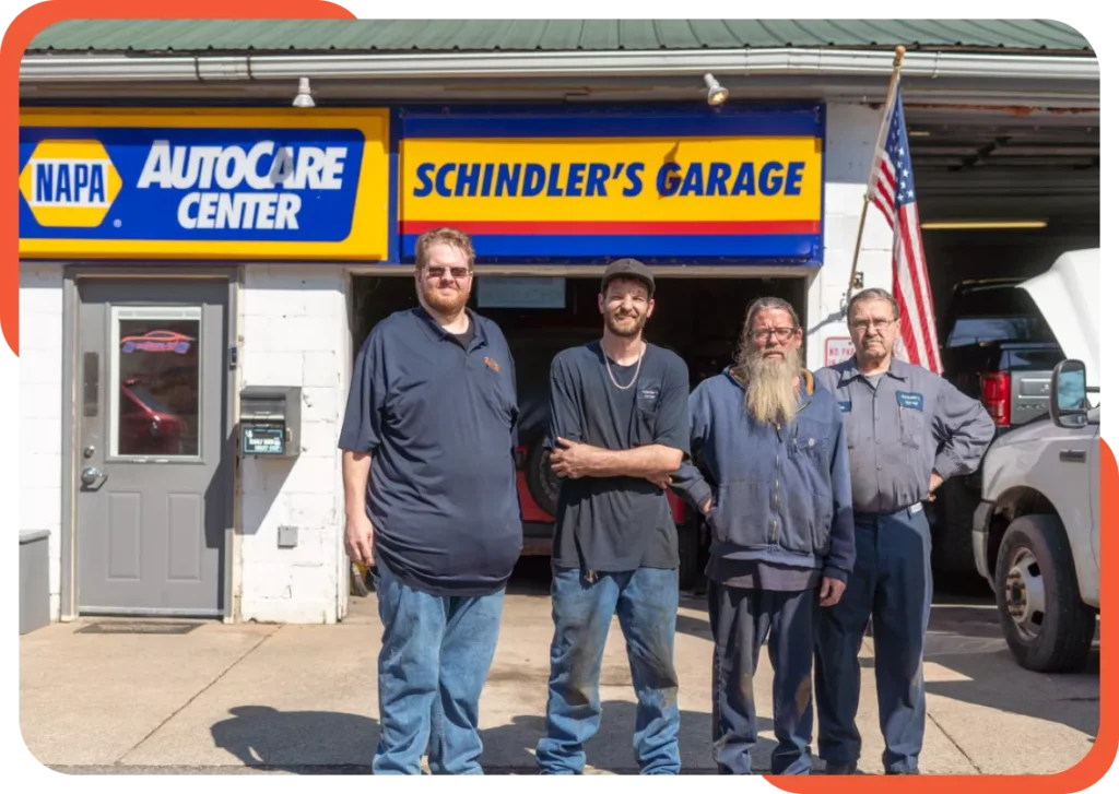 Team at Schindler's Garage posing in front of the shop exterior.