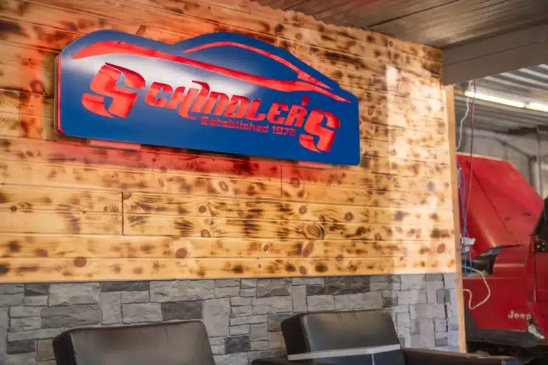 Interior signage displayed prominently in the reception area of Schindler's Garage, providing information and guidance for customers