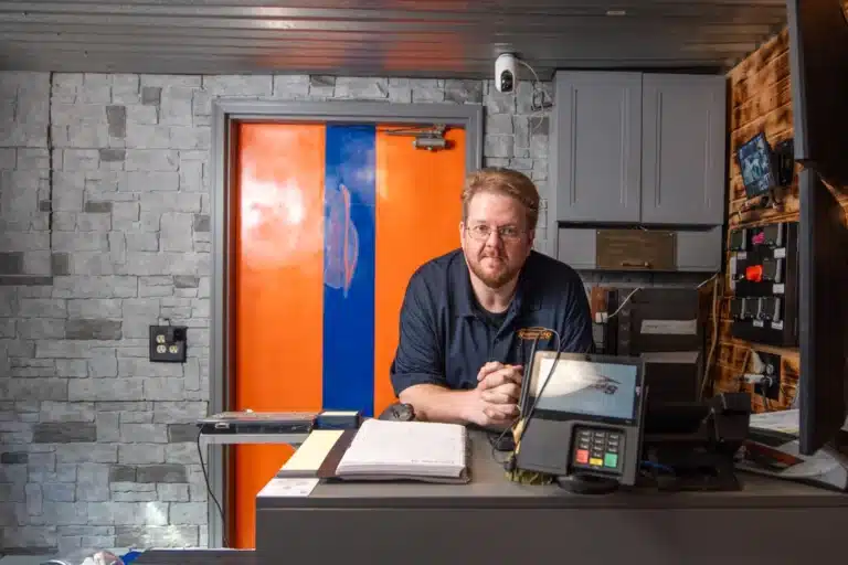 Joe Schindler, owner of Schindler's Garage, at the reception desk.