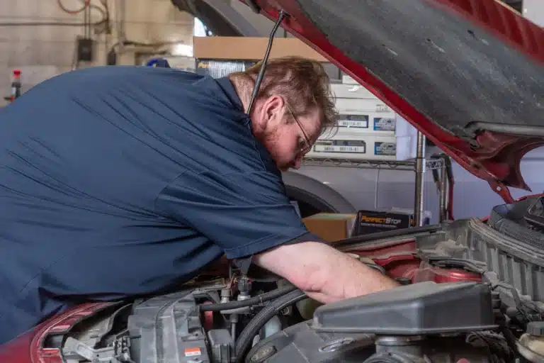 Technician performing a thorough engine inspection at Schindler's Garage.