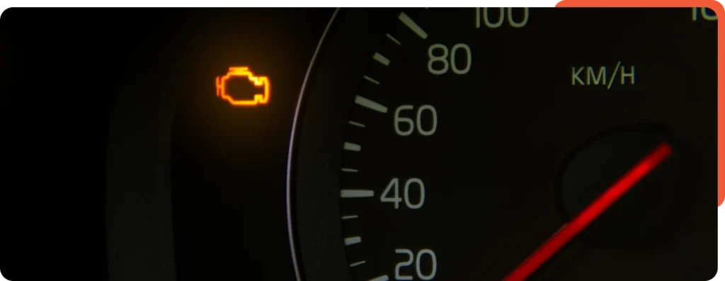 Dashboard of a vehicle with the check engine light illuminated, indicating a potential issue requiring diagnostics or repair.