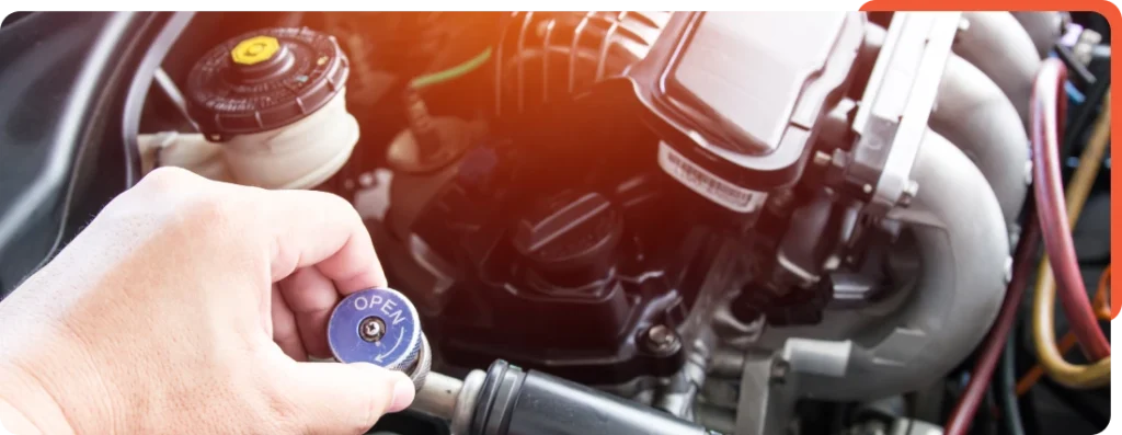 echnician inspecting and servicing coolant system components at Schindler's Garage, ensuring proper cooling efficiency and maintenance.