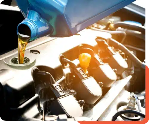 Close-up of fresh motor oil being poured into a car's engine during service at Schindler's Garage.