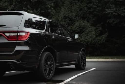 Common Dodge Issues in Fall: What Every Owner in Floyds Knobs Should Watch For From Schindler’s Garage. A black 2019 Dodge Durango from the rear, displaying its contemporary design and distinctive tail lights.