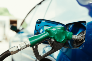 Learn how to boost your cars fuel efficiency in 2025 with preventative maintenance at Schindler's Garage in Floyd Knobs, IN. Image of green gas pump filling up gas in a car.