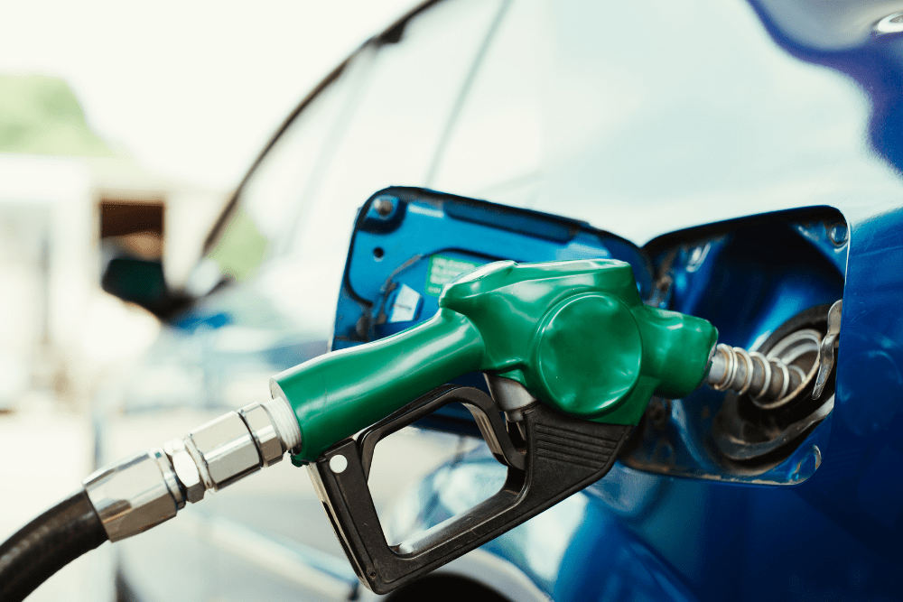 Learn how to boost your cars fuel efficiency in 2025 with preventative maintenance at Schindler's Garage in Floyd Knobs, IN. Image of green gas pump filling up gas in a car.