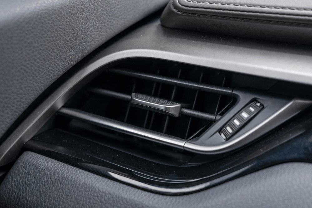a/c repair, auto repair in Floyds Knobs, IN at Schindler's Garage. Close-up of a car’s dashboard air conditioning vent, highlighting airflow direction controls and vent detail. Ideal for illustrating cabin comfort or vehicle HVAC performance.