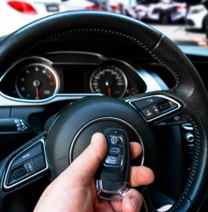 Close-up of a key fob being programmed with the vehicle's electronic system.