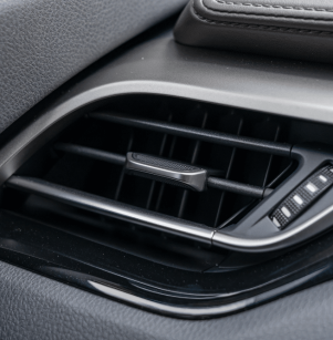 a/c repair, auto repair in Floyds Knobs, IN at Schindler's Garage. Close-up of a car’s dashboard air conditioning vent, highlighting airflow direction controls and vent detail. Ideal for illustrating cabin comfort or vehicle HVAC performance.