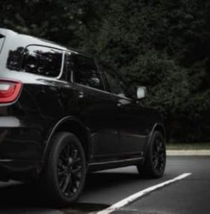 Common Dodge Issues in Fall: What Every Owner in Floyds Knobs Should Watch For From Schindler’s Garage. A black 2019 Dodge Durango from the rear, displaying its contemporary design and distinctive tail lights.