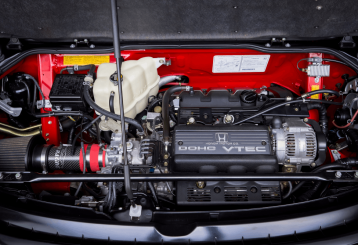 Honda services and maintenance in Floyds Knobs, IN by Schindler’s Garage. Image of a clean Honda DOHC VTEC engine bay with components exposed for diagnostics, highlighting professional maintenance and performance-focused automotive service.