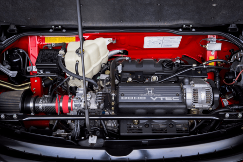 Honda services and maintenance in Floyds Knobs, IN by Schindler’s Garage. Image of a clean Honda DOHC VTEC engine bay with components exposed for diagnostics, highlighting professional maintenance and performance-focused automotive service.