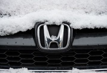 Honda winter maintenance tips in Flyods. Knobs, IN with Schindler's Garage. Image of honda car ornament on grill of car with snow on it.